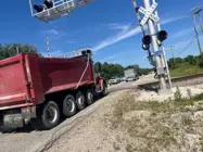 Dump truck crossing railroad tracks on highway K