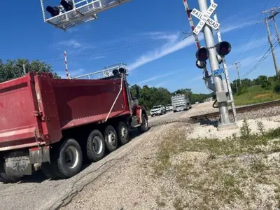 Dump truck crossing railroad tracks on highway K