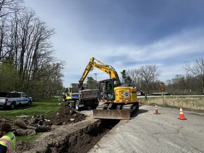 Excavator with patrol truck