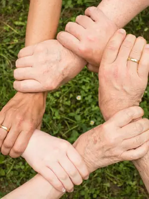 Multiple Hands Intertwined Together