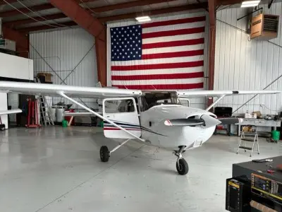 Airplane in hangar with American flag in background