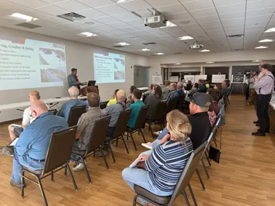 Engineering manager presenting to audience at public information meeting