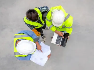 Stock photo of engineers communicating over plans